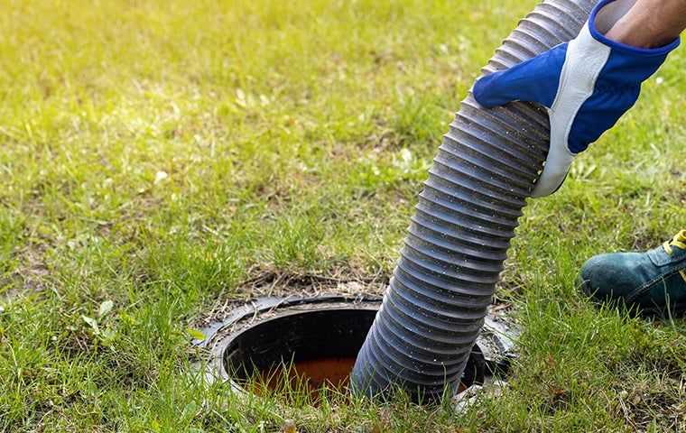 technician pumping septic tank